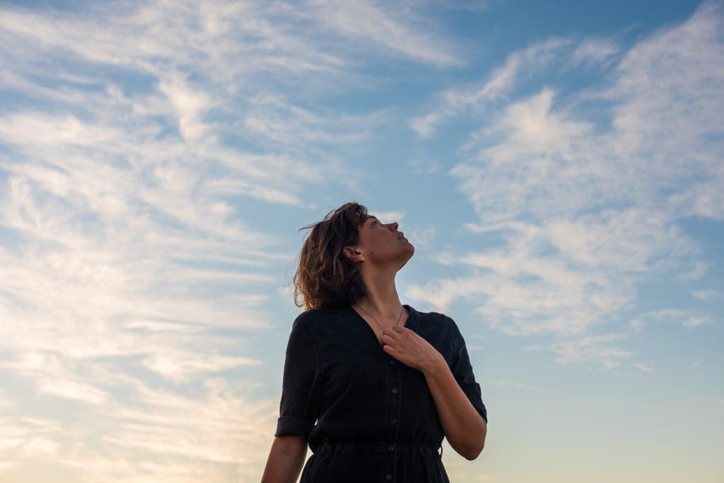 a woman looking up into the sky after she had completed ozone sauna therapy