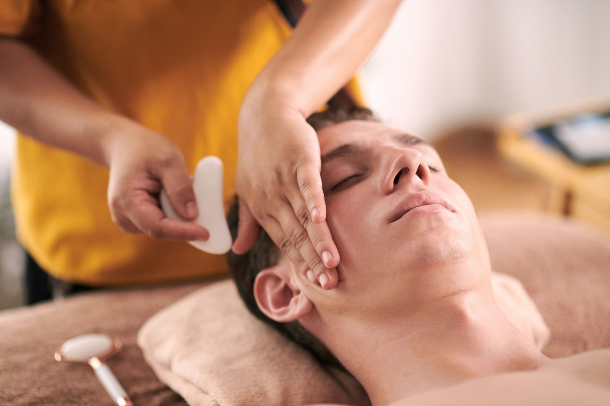 Massaging Face with Gua Sha