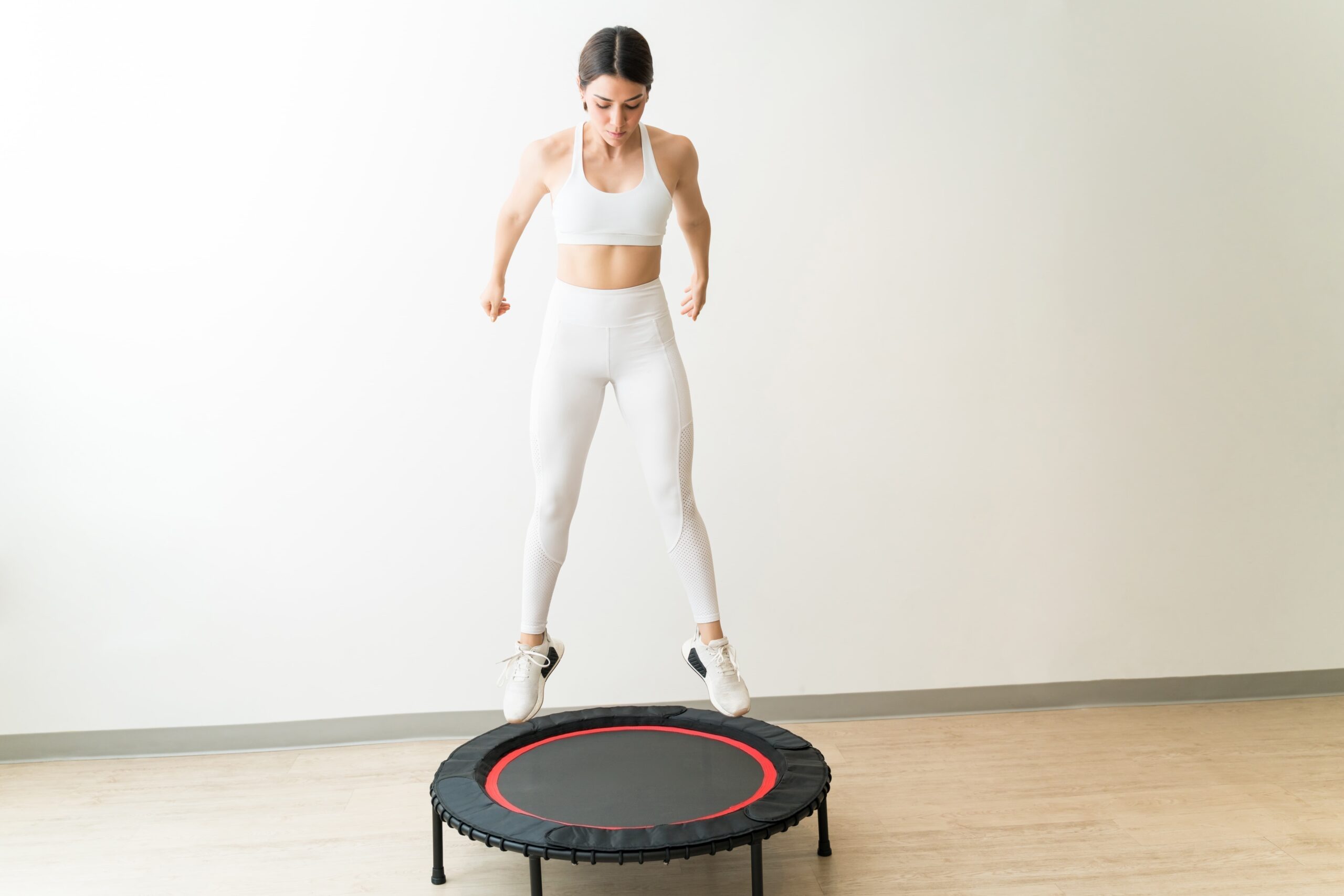 Person using rebounder therapy to support blood sugar and metabolic wellness at a spa