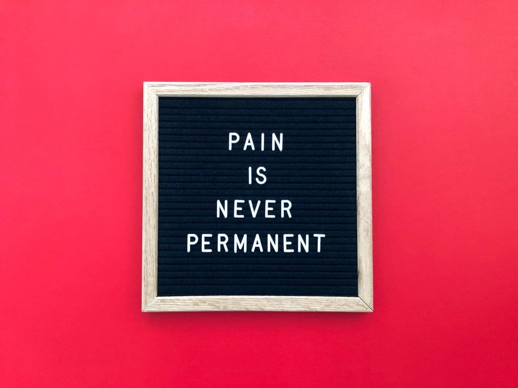 a sign that says "pain is never permanent" highlighting red light therapy for pain and inflammation