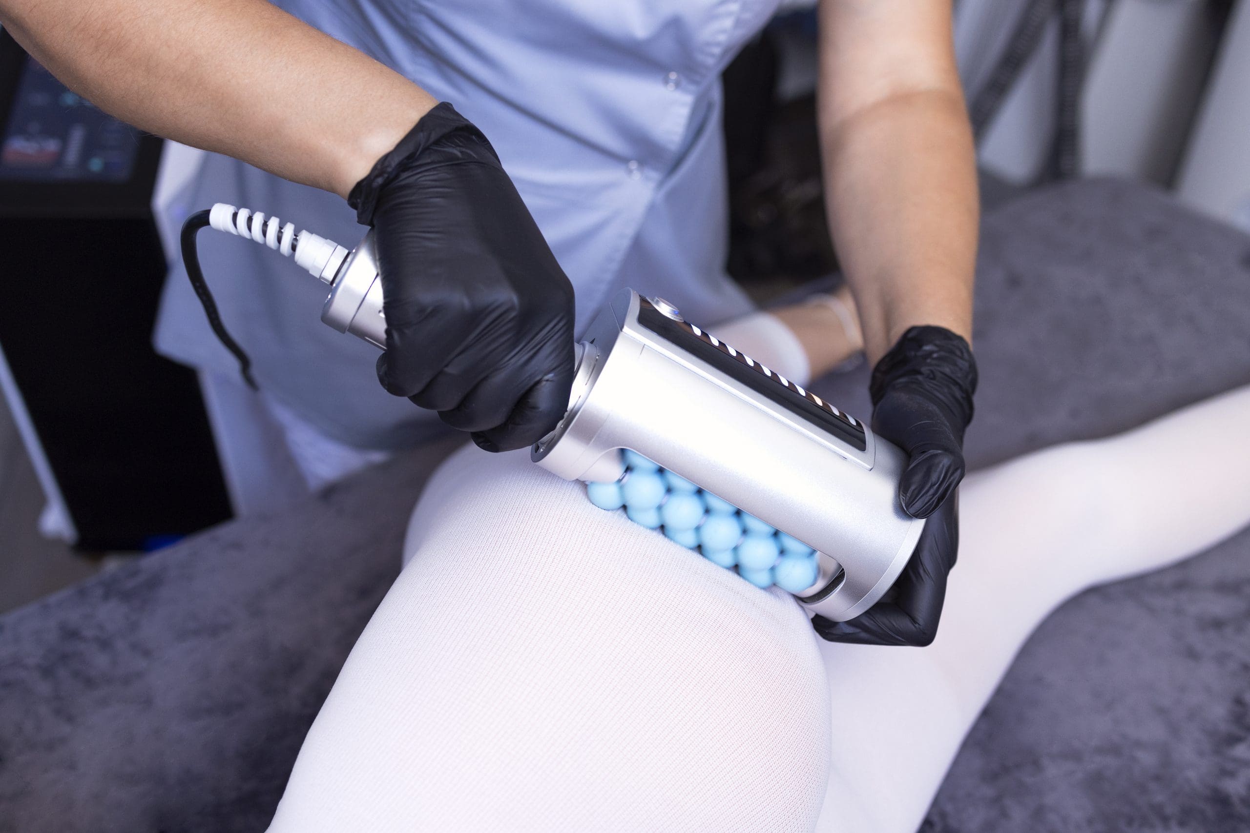 Beautician using an endospheres device on a client's leg showing the various parts of the body treated with endospheres therapy