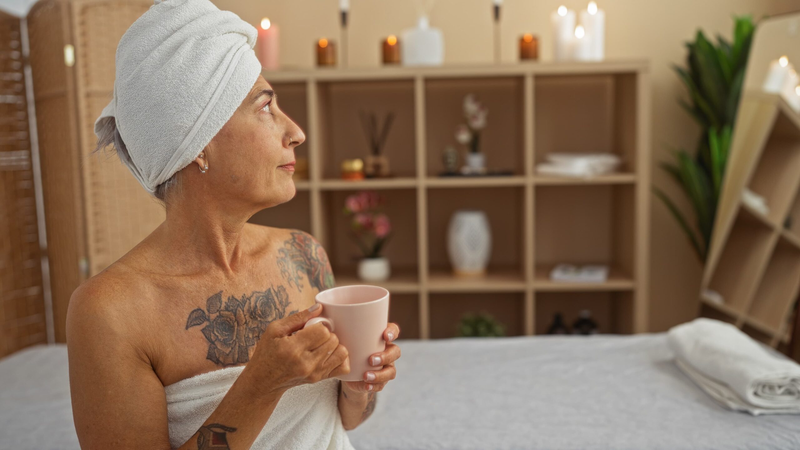 Client relaxing with water after an ozone sauna session at a wellness spa