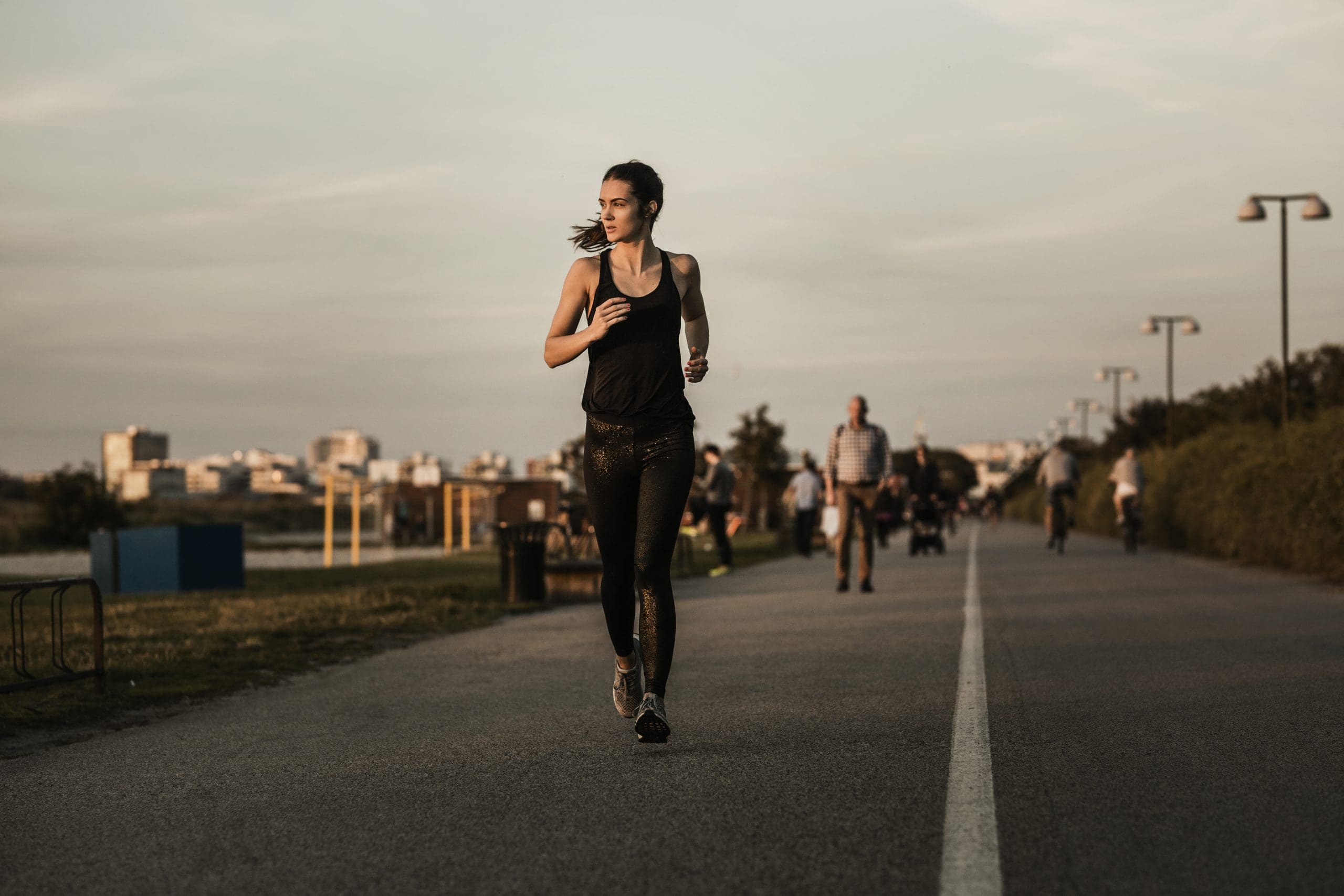 a woman running on the street wondering if rebounder vs. running gives better results