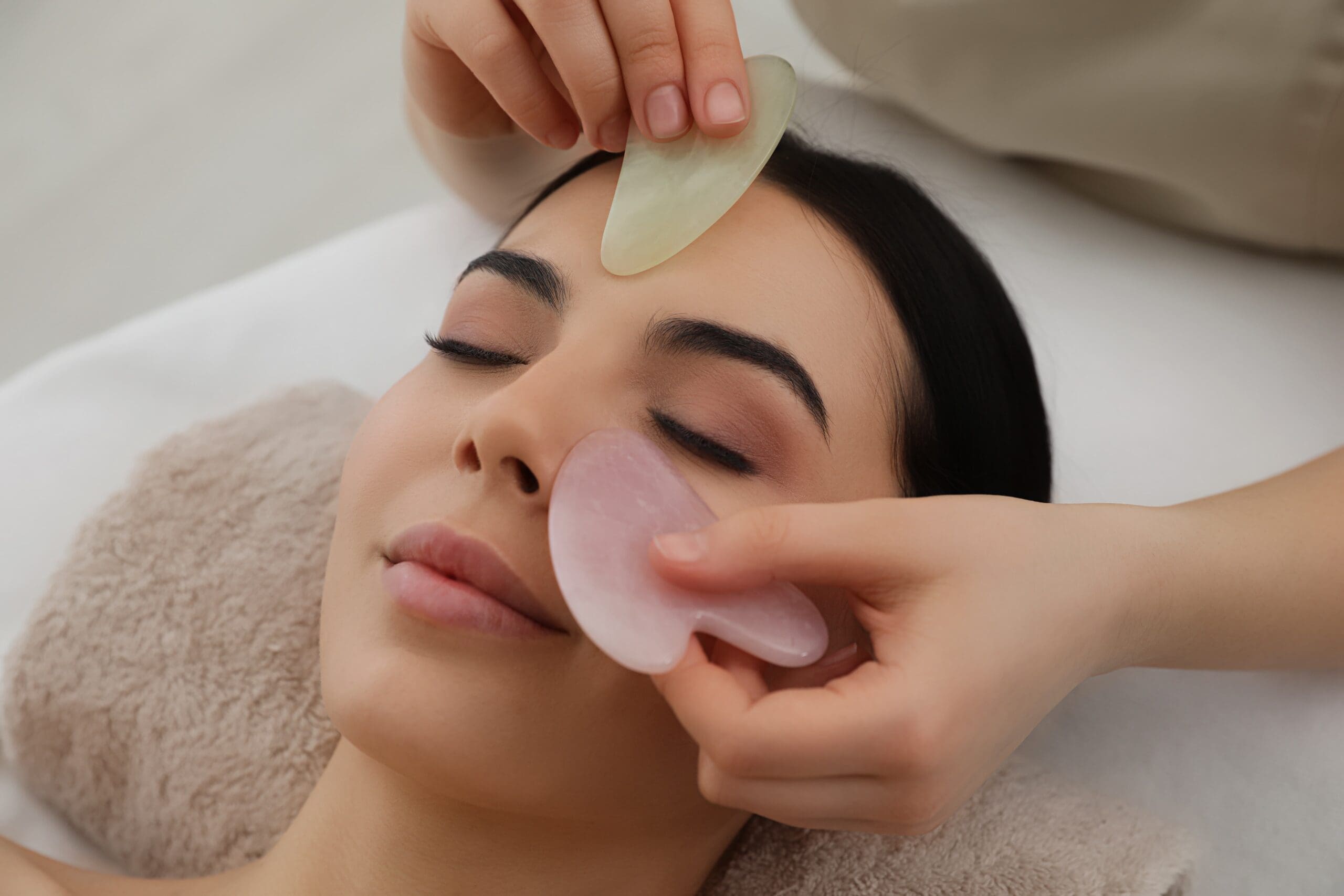 Client receiving Gua Sha Facial at Empower Wellness Spa