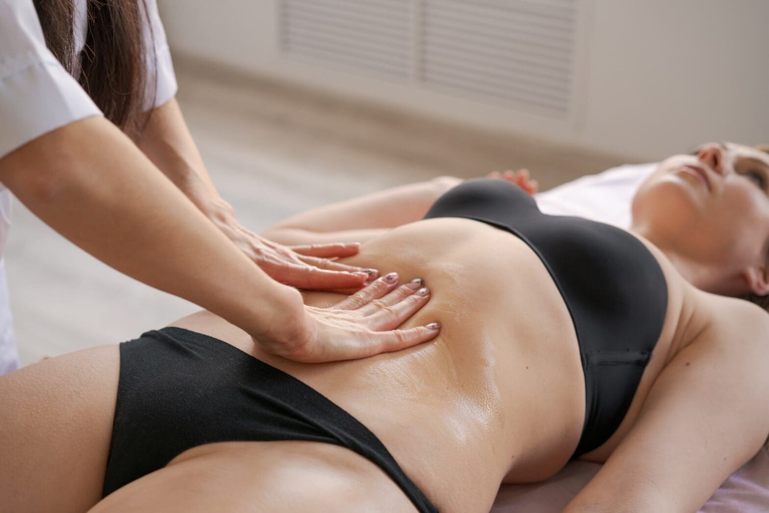 client receiving lymphatic drainage massage at wellness spa