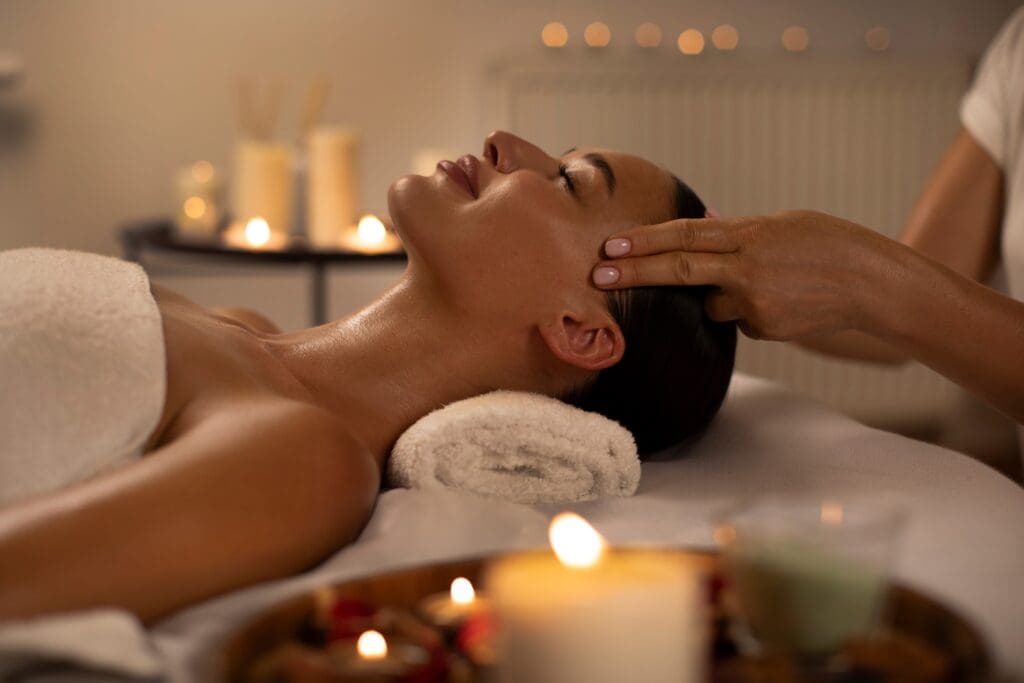 Woman with glowing skin smiling peacefully during a spa session