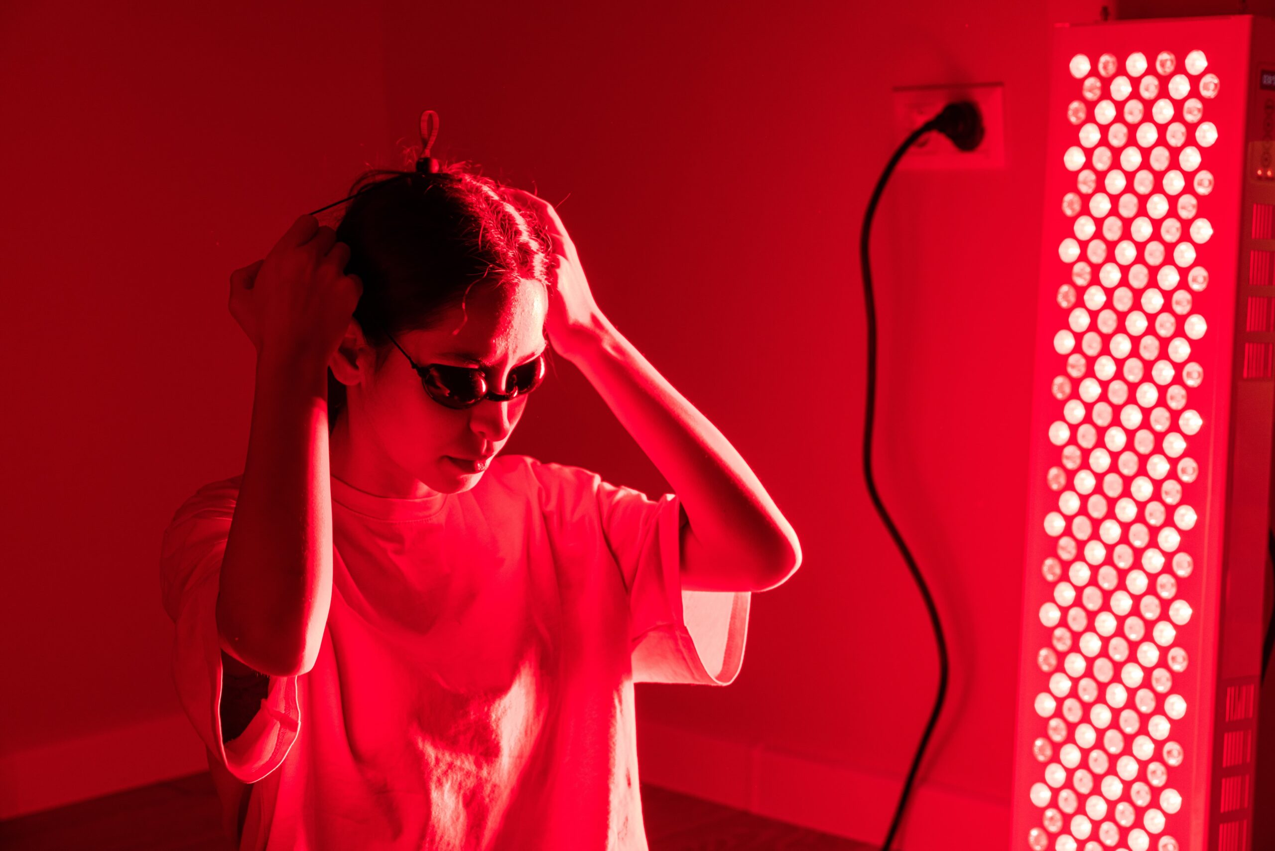 pa therapist preparing red-light therapy session for a wellness member at Empower Wellness Spa