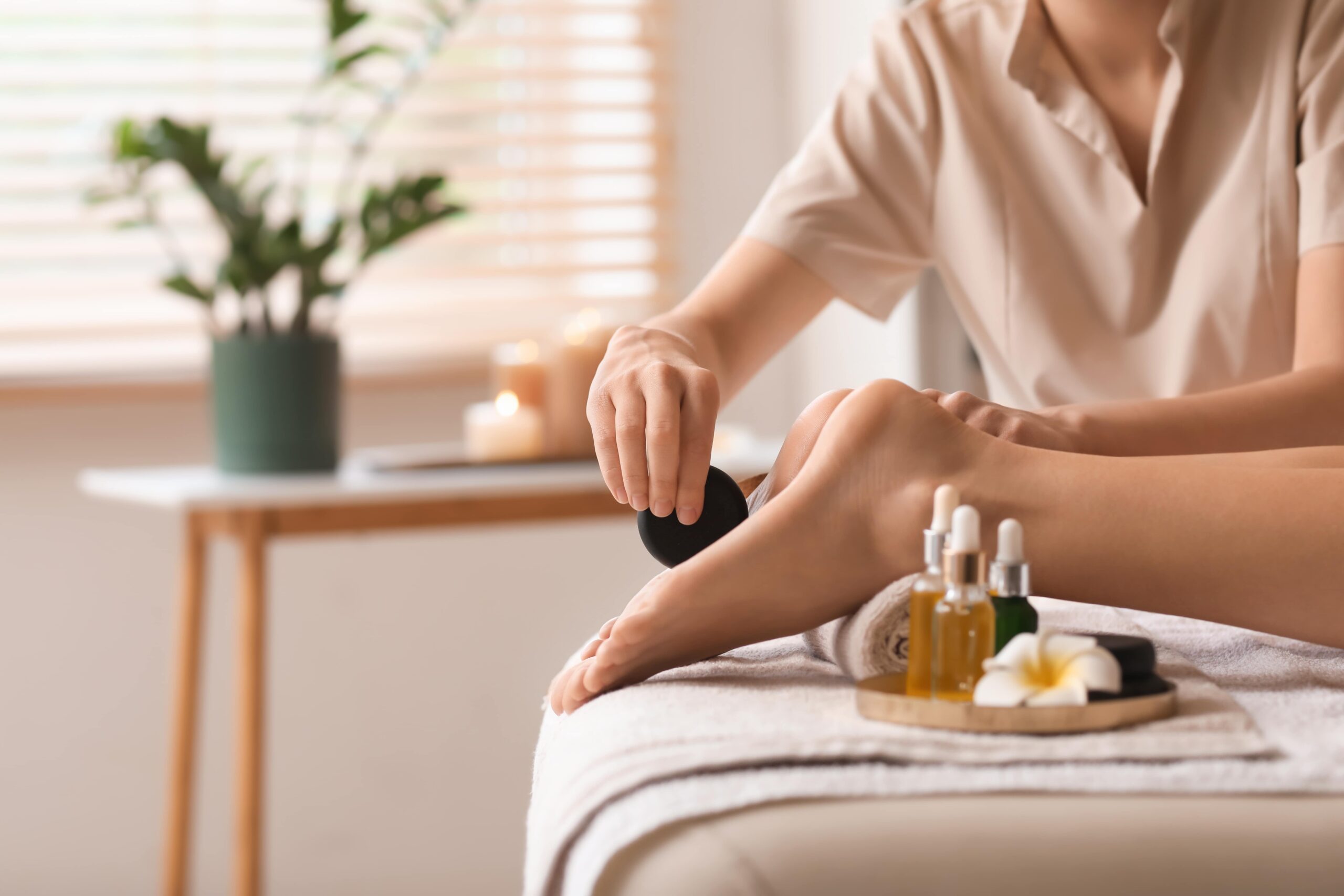 foot zoning chart guide — therapist performing professional foot zone therapy session at Encino wellness spa